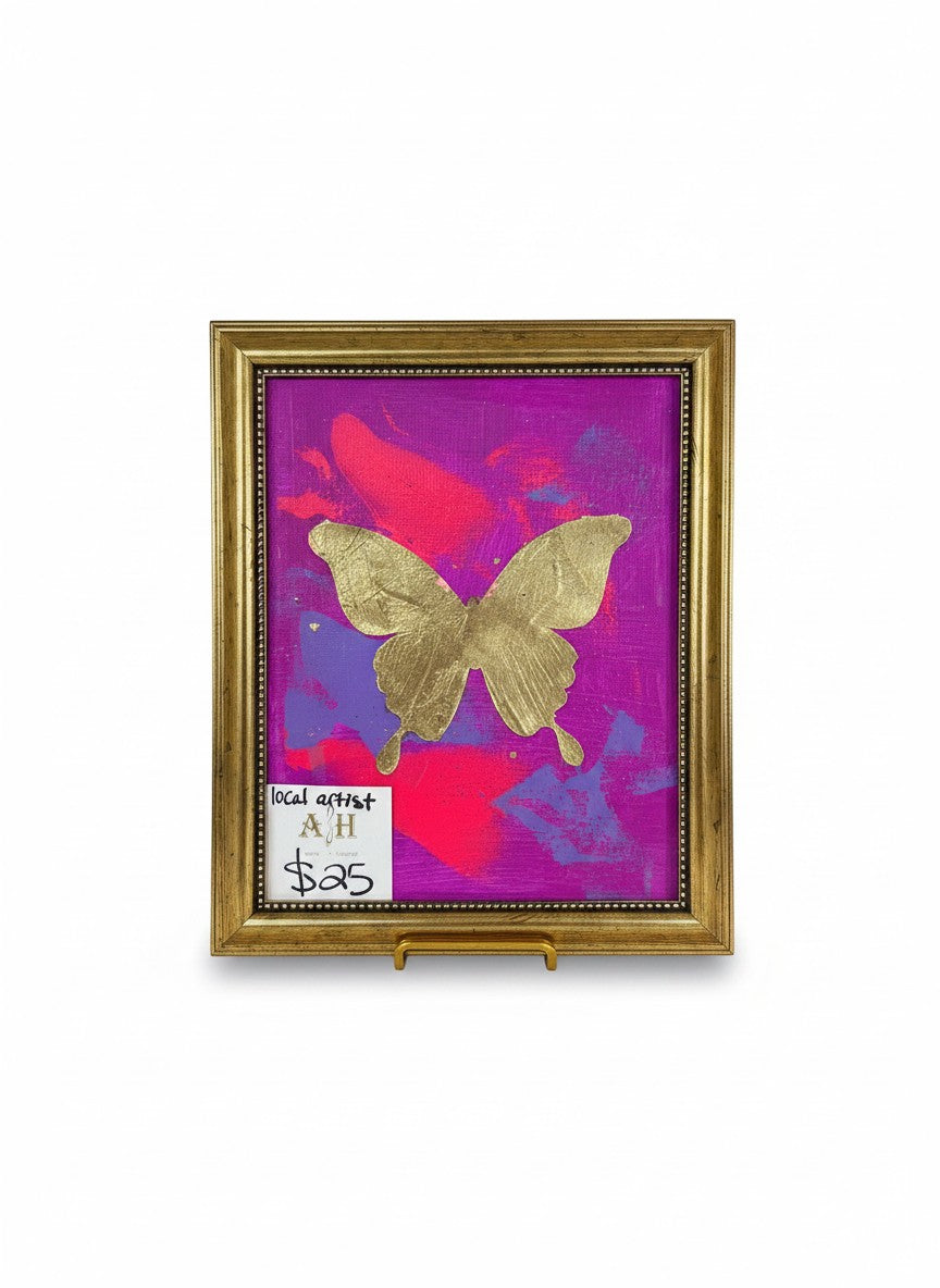 Chic Collective Violet Flight painting with gold butterfly on vibrant magenta, orchid, fuchsia, and violet background. Ornate gold frame.