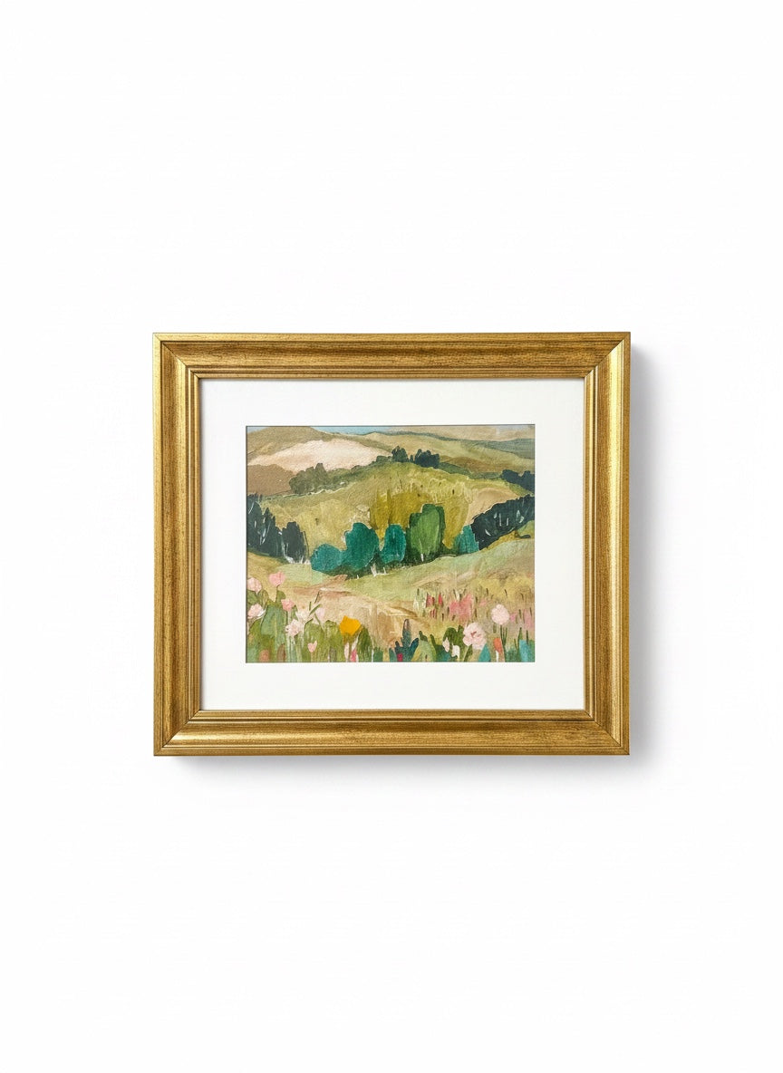 Chic Collective Whispering Hills framed landscape painting with rolling hills, trees, and wildflowers in muted greens, sage, blush, and blue.
