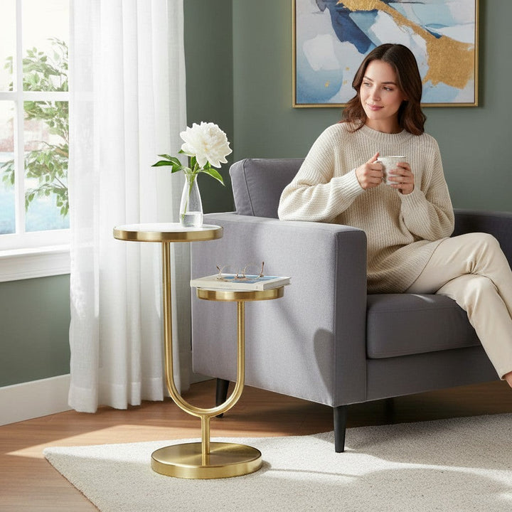 Chic Collective 22" white marble and gold iron two-tier round end table with a U-shaped base, perfect for living rooms or bedrooms.