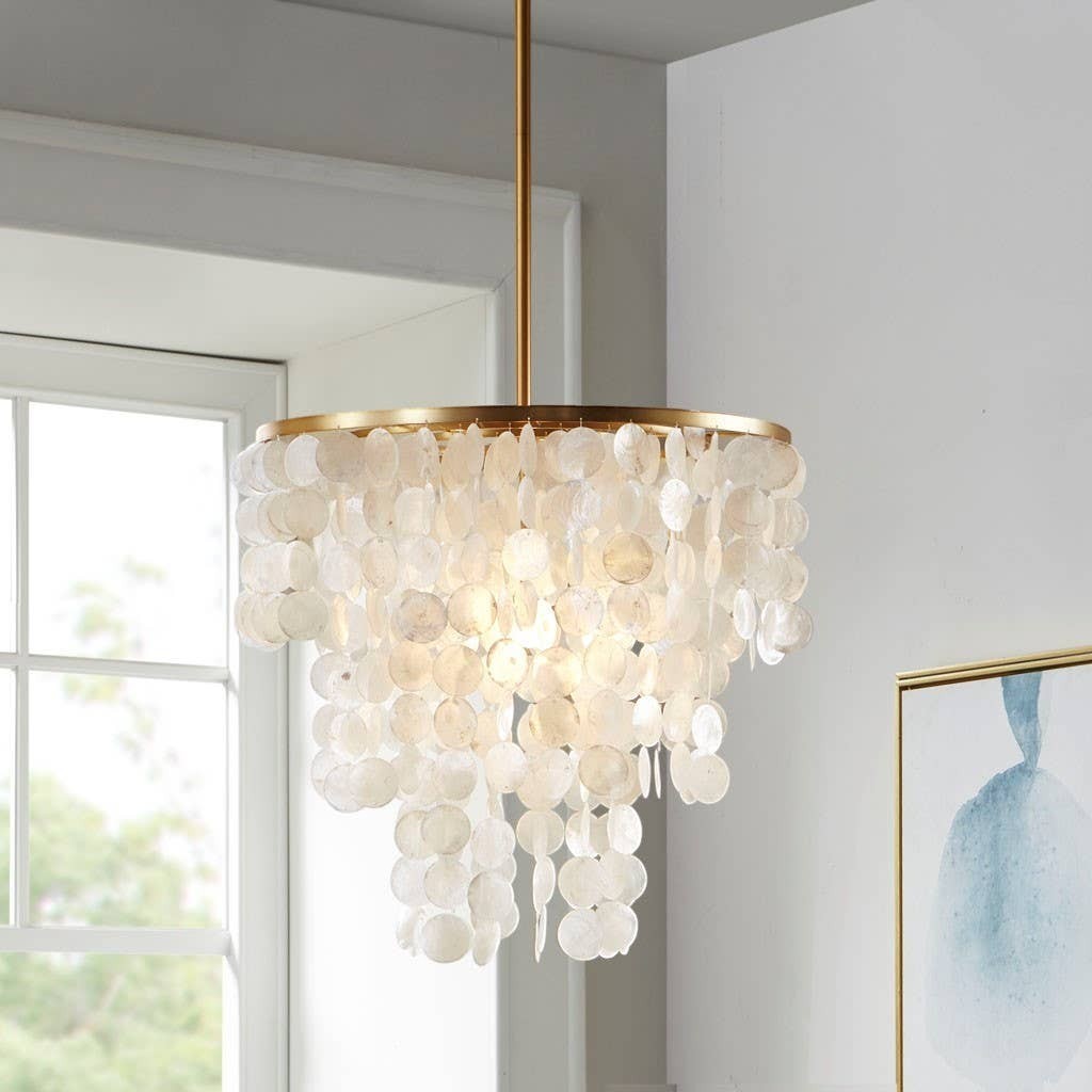 Chic Collective white shell chandelier with gold base, featuring draped shell discs cascading down.