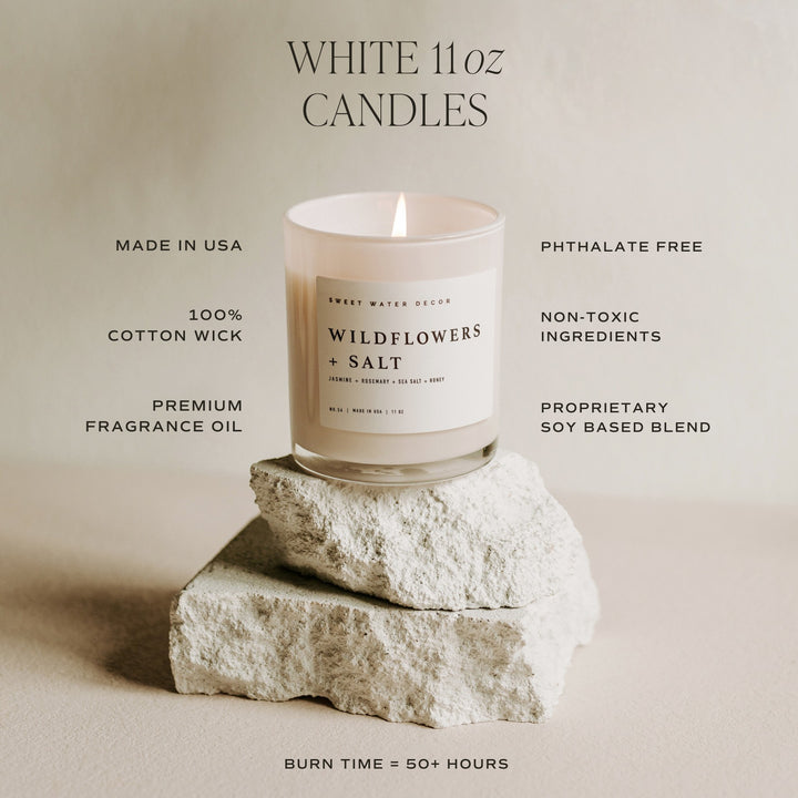 Chic Collective white 11 oz soy candle with Wildflowers + Salt scent, made with cotton wick and premium fragrance oil.