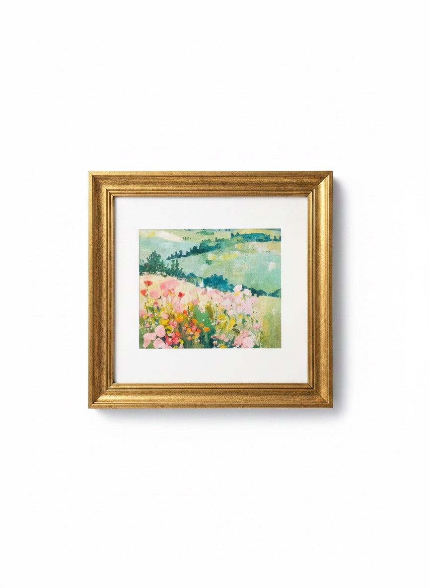 Chic Collective Where Wildflowers Wander framed artwork features a soft, romantic landscape painting with blush pink florals and sage green hills.