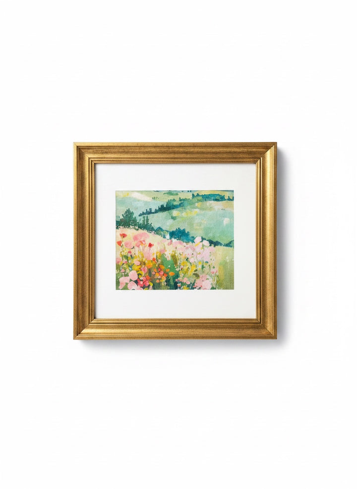 Chic Collective Where Wildflowers Wander framed artwork features a soft, romantic landscape painting with blush pink florals and sage green hills.