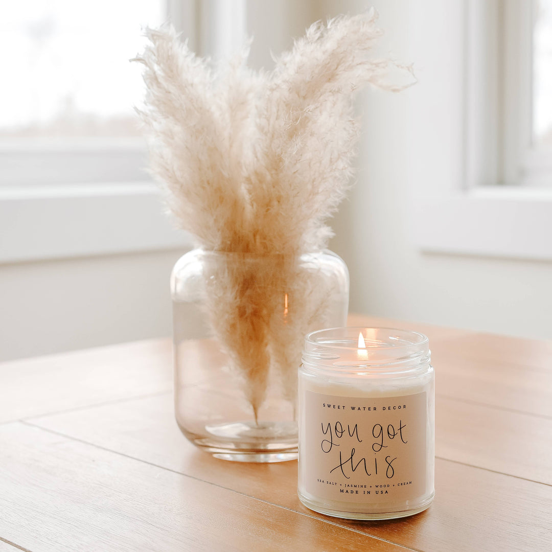 Chic Collective You Got This 9 oz soy candle with Spa Day scent notes, in a clear glass jar with a light brown label.