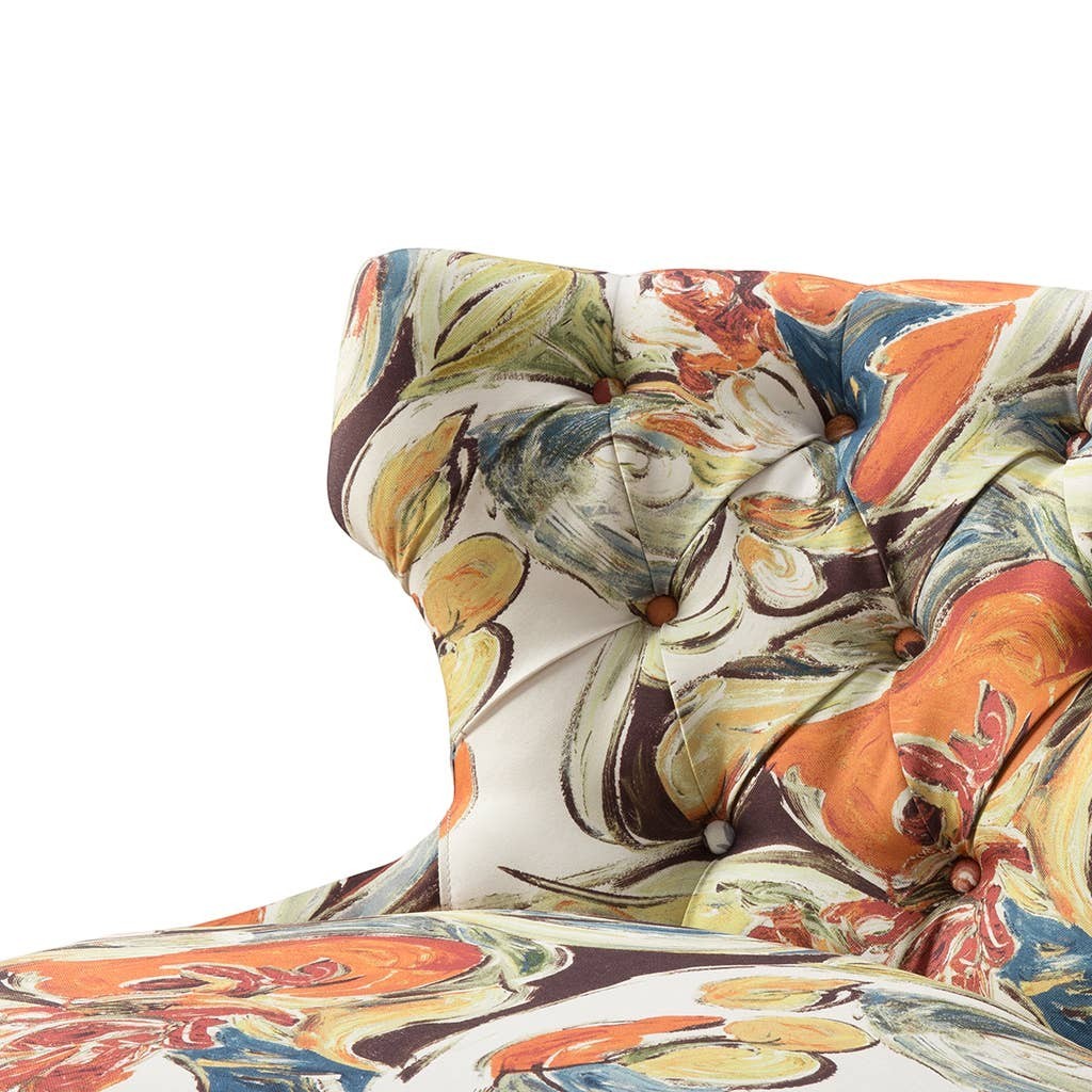 Chic Collective armless slipper chair with abstract floral print upholstery in orange, yellow, blue, and green. Tufted back with wood buttons.