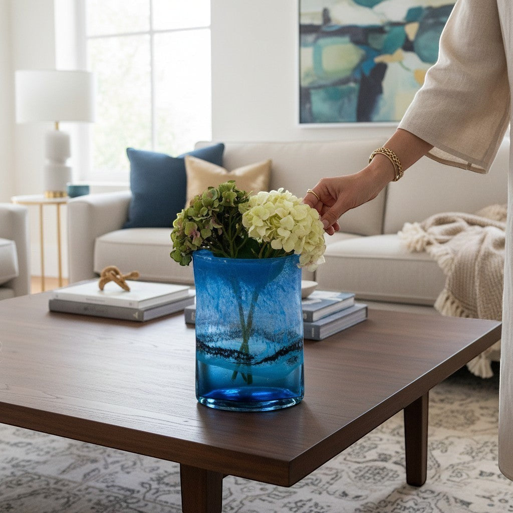 Chic Collective Alaborg hand-blown cobalt blue glass vase with swirling aqua accents, holding hydrangeas.