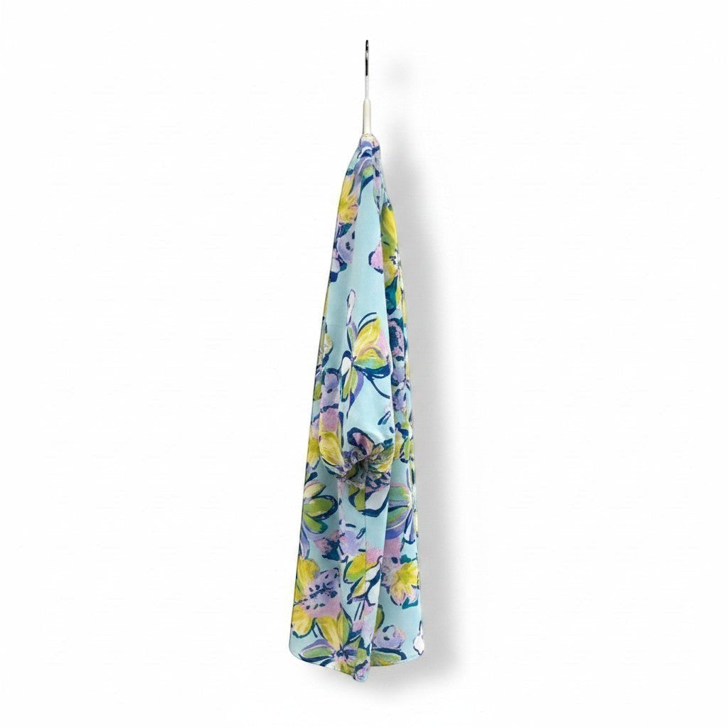 Chic Collective aqua, yellow, green, and blue floral bubble sleeve top with a vibrant floral print.
