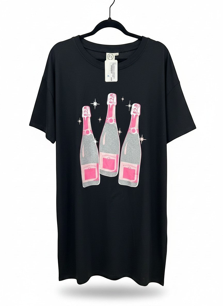 Chic Collective black oversized tunic with a graphic of three glittery champagne bottles with pink accents.