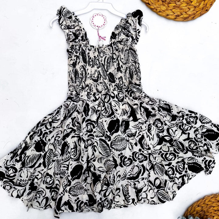Chic Collective black and cream floral print smocked mini dress with flutter sleeves.