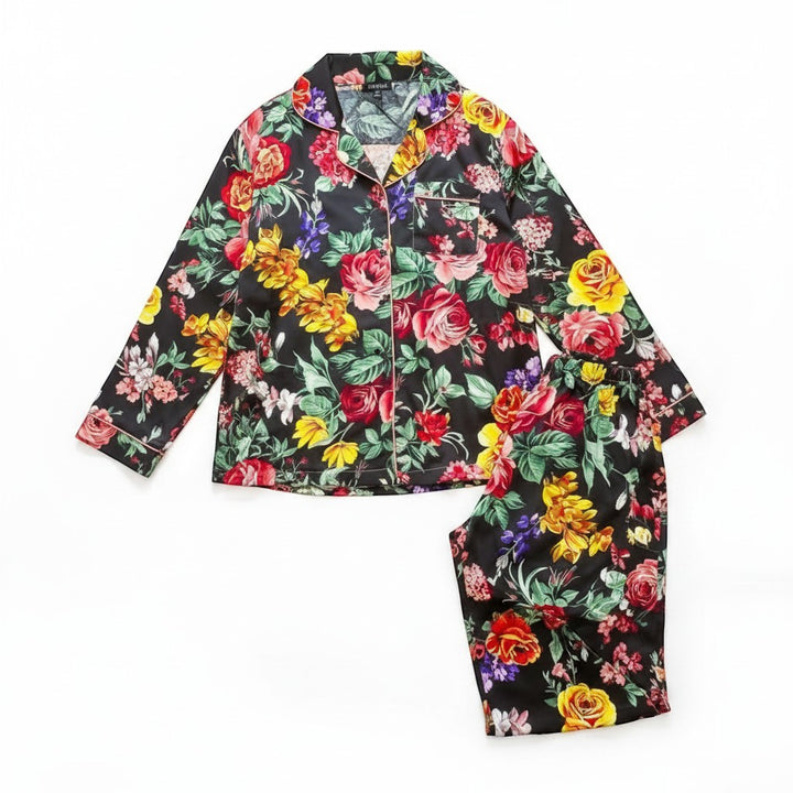 Chic Collective black satin pajama set with a vibrant floral print. Features a collared long-sleeve top and matching shorts.