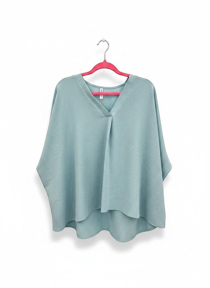 Chic Collective light blue textured V-neck dolman top with relaxed sleeves and a high-low hem.