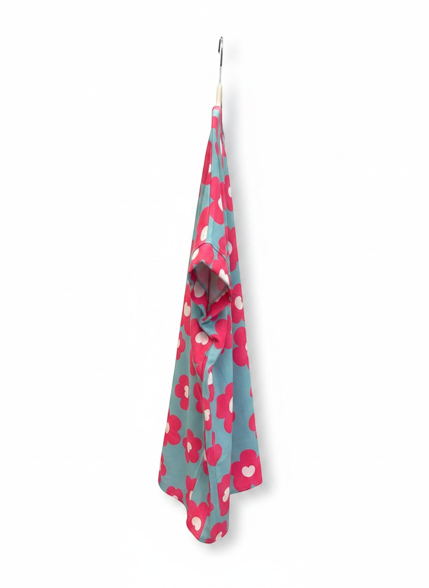 Chic Collective blue V-neck top with large pink and white floral print, short cuffed sleeves.