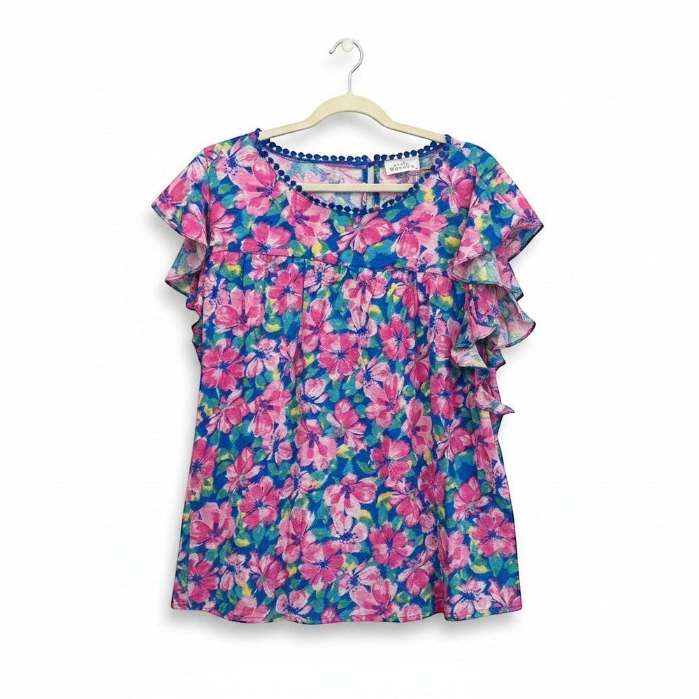 Chic Collective blue and pink hibiscus floral print ruffle top with pom-pom trim.