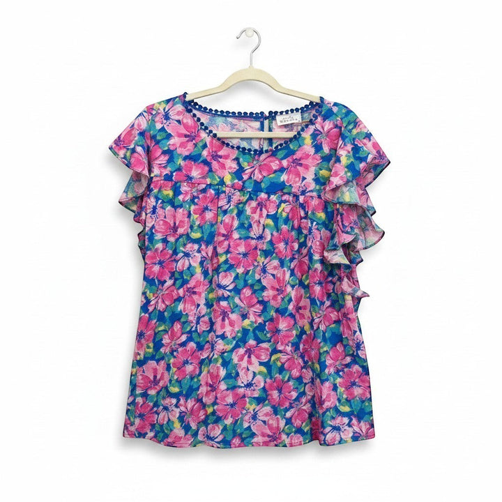Chic Collective blue and pink hibiscus floral print ruffle top with pom-pom trim.
