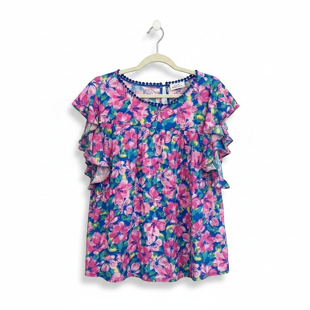 Chic Collective blue and pink hibiscus floral print ruffle top with pom-pom trim neckline.