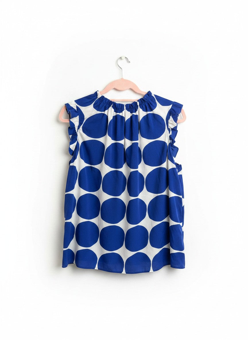 Chic Collective blue and white polka dot sleeveless blouse with ruffle neckline and sleeves.