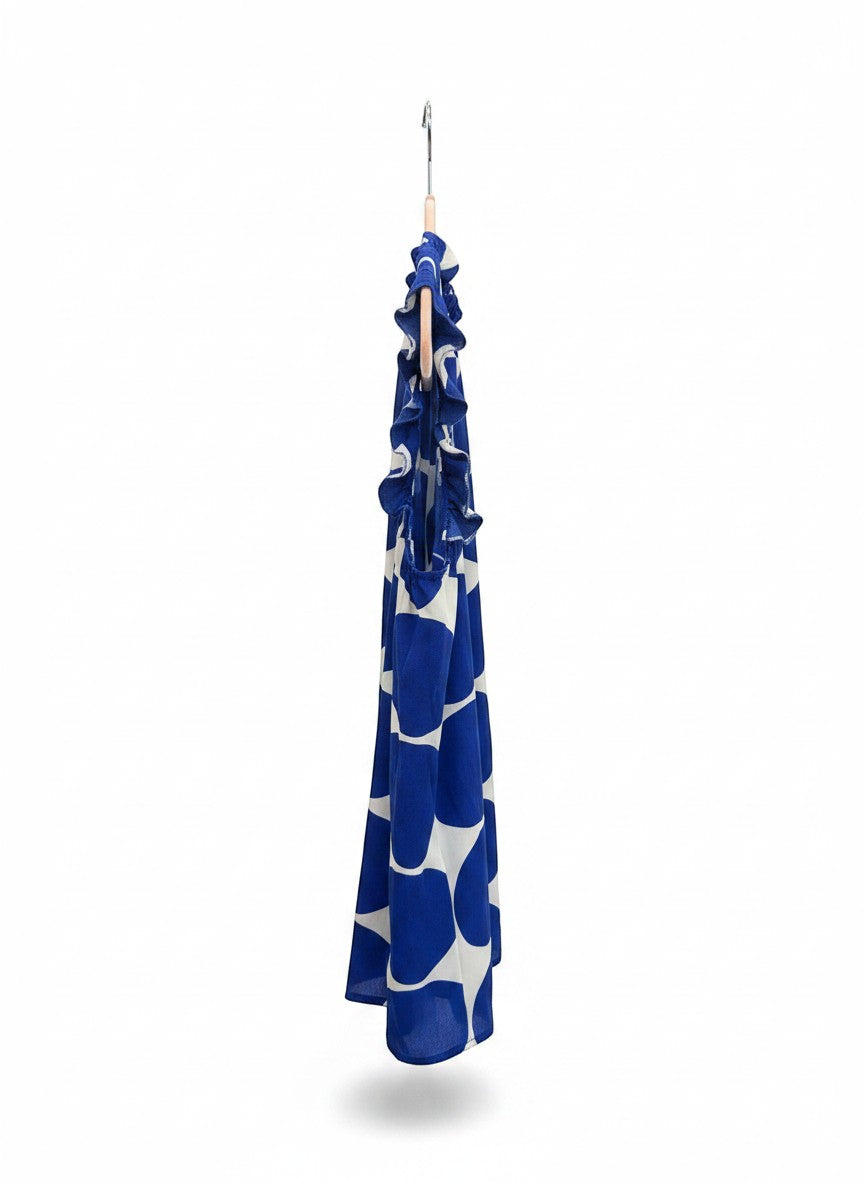 Chic Collective blue and white polka dot sleeveless blouse with ruffle neckline and hem.