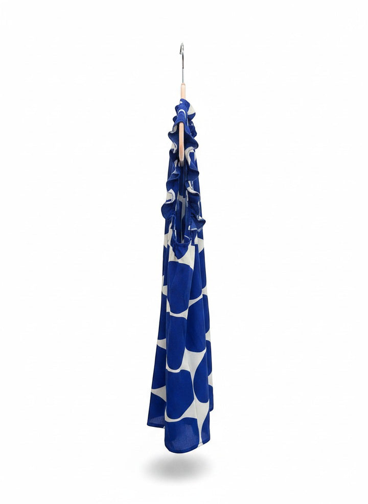 Chic Collective blue and white polka dot sleeveless blouse with ruffle neckline and hem.