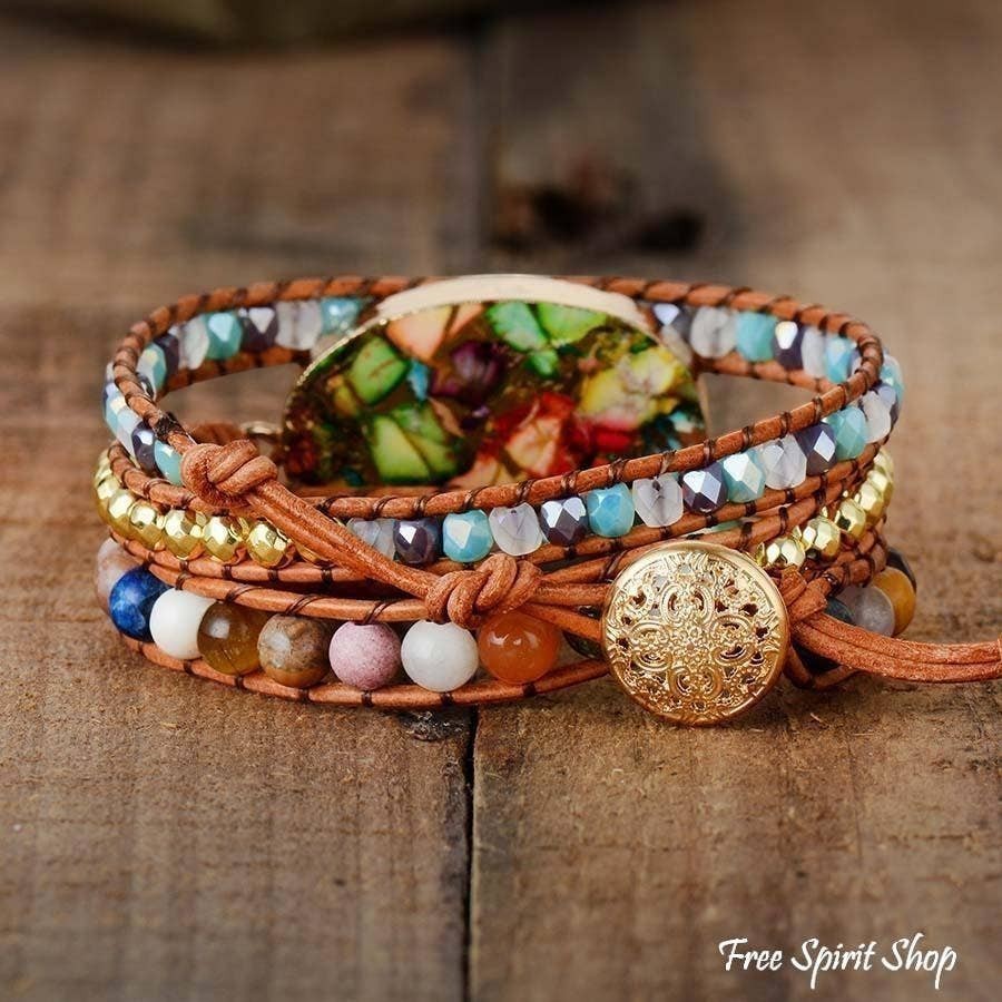 Chic Collective handmade boho wrap bracelet with color splash jasper, natural stones, and genuine leather on a wooden background.