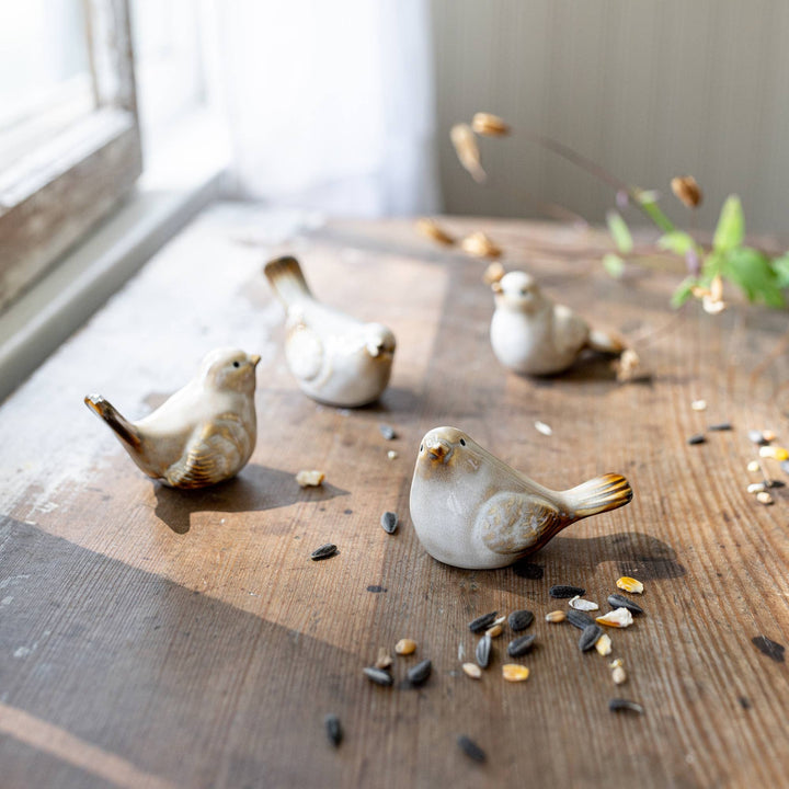 Chic Collective Nalin Set of 4 cream ceramic bird accents with reactive glaze finish, in various poses.