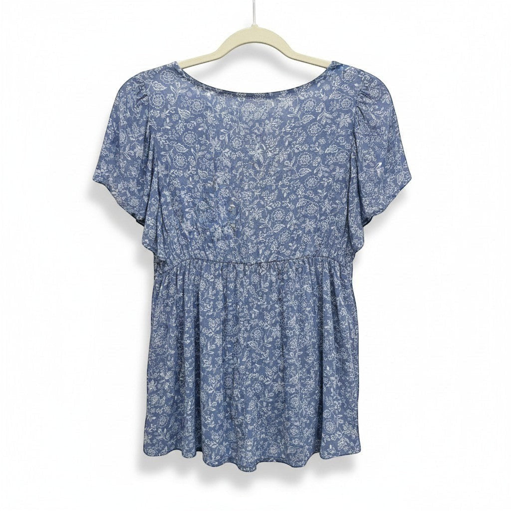 Chic Collective denim blue v-neck woven top with white floral print and flutter sleeves.