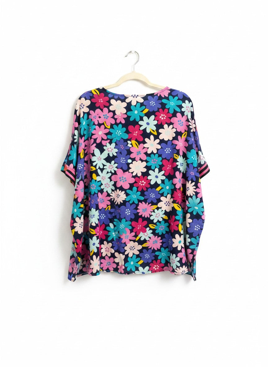 Chic Collective floral print V-neck kaftan top in navy with pink, blue, and teal flowers. Lightweight, flowy fit.