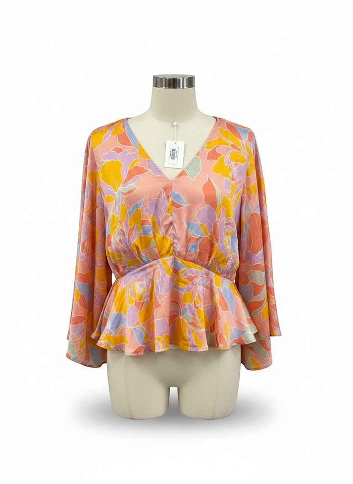 Chic Collective floral print peplum blouse with V-neckline, cinched waist, and flowy sleeves in peach, yellow, lavender, and blue.