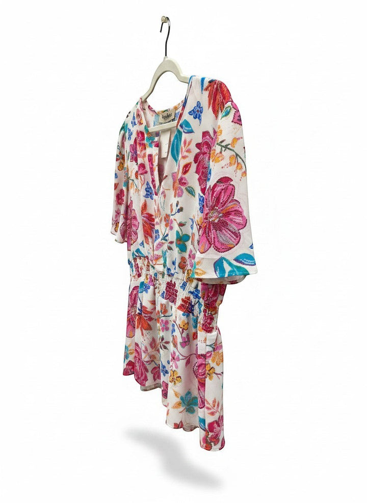 Chic Collective floral print blouse with ivory, hot pink, and blue flowers, smocked waist, and flutter sleeves.