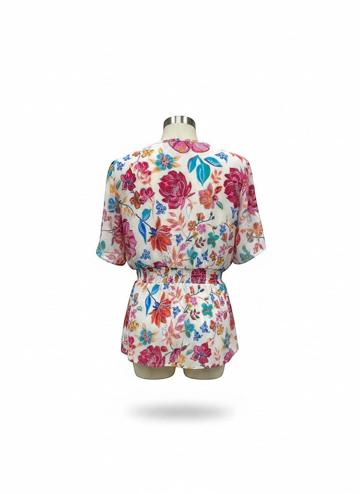 Chic Collective ivory blouse with vibrant floral print in hot pink and blue, featuring a smocked waist for a flattering fit.