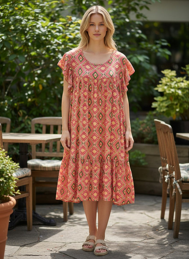 Chic Collective coral, yellow, and green geometric print tiered midi dress with ruffle sleeves.
