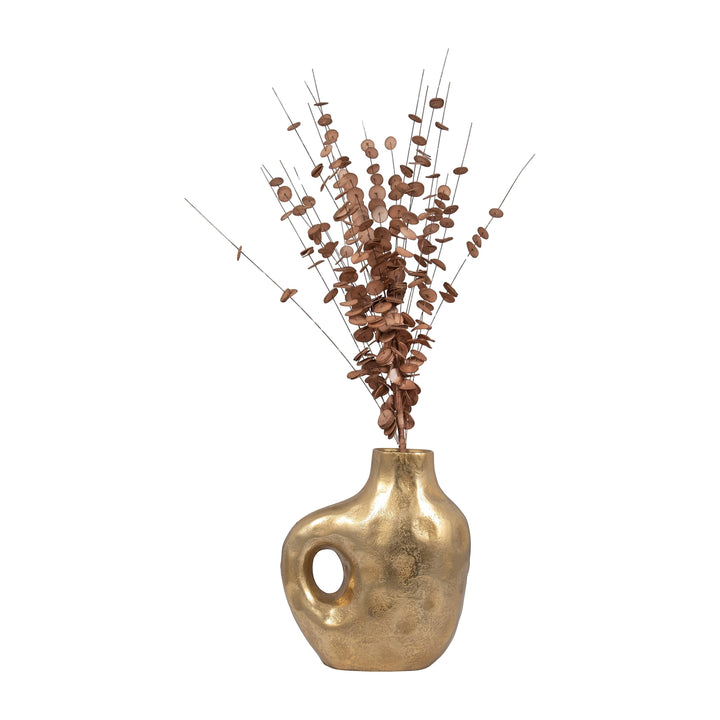 Chic Collective gold aluminum vase with hammered finish and cut-out detail, holding dried decorative branches.