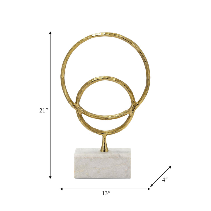 Chic Collective gold metal double ring sculpture with hammered texture on a white marble base, 21 inches tall.
