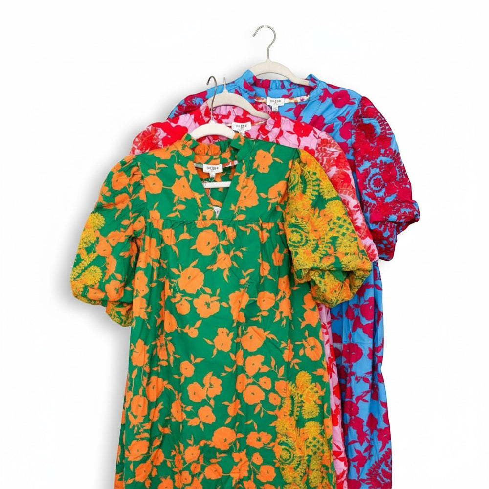 Chic Collective green top with orange floral print and puff sleeves, also showing blue and red floral print tops.