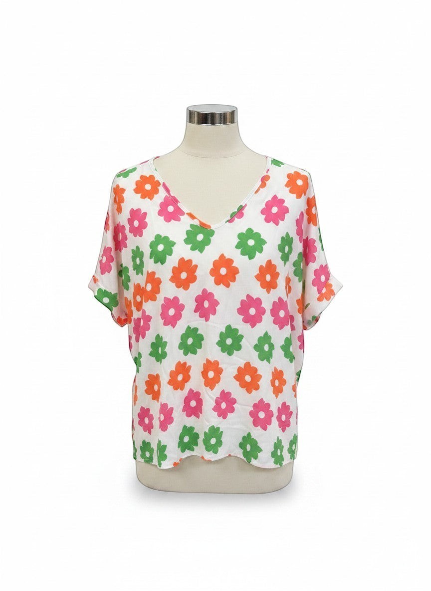 Chic Collective ivory top with a repeating pattern of pink, coral, and green flowers. V-neck, dolman sleeves.