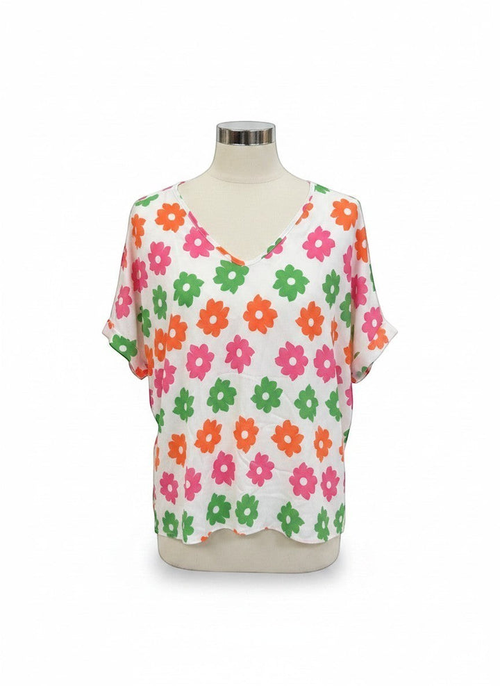 Chic Collective ivory top with a repeating pattern of pink, coral, and green flowers. V-neck, dolman sleeves.
