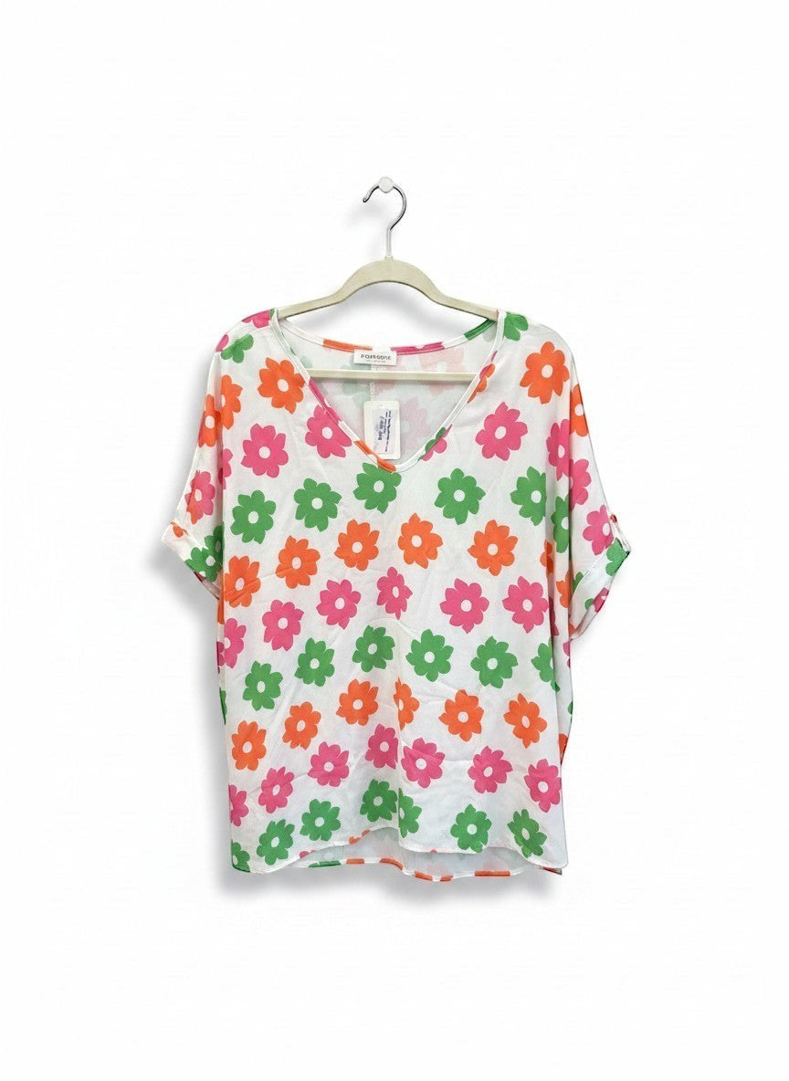 Chic Collective ivory top with a repeating pattern of pink, orange, and green flowers. V-neck, dolman sleeves.