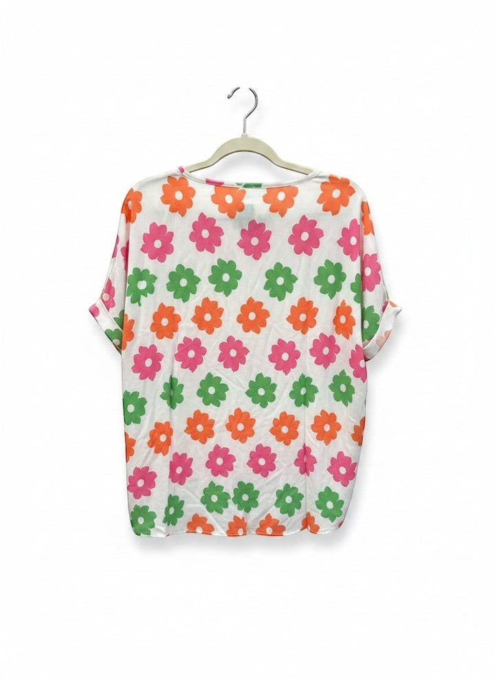 Chic Collective ivory white dolman top with a repeating floral print in pink, coral, and green.