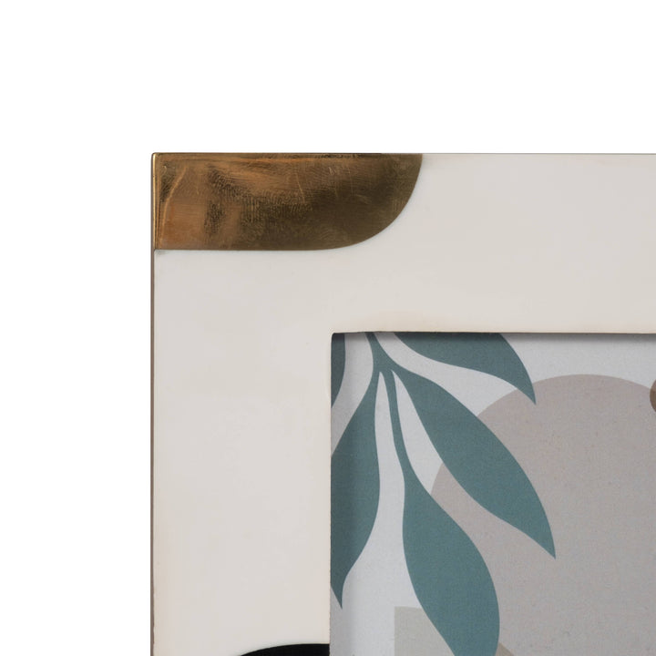 Chic Collective ivory, brown, and gold resin photo frame with brass corner accents. Holds a 4x6 inch photo.