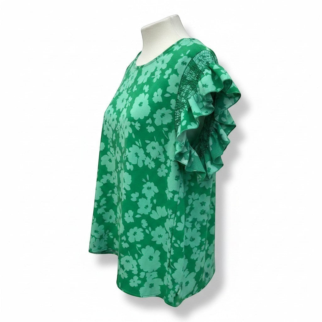 Chic Collective Kelly green woven blouse with smocked shoulders and frilly short sleeves, featuring a light green floral print.