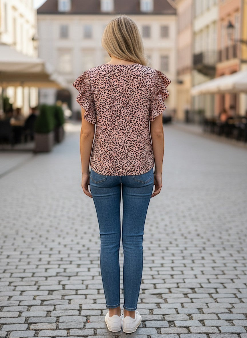 Chic Collective mauve and black leopard print top with ruffle sleeves, paired with blue denim jeans.