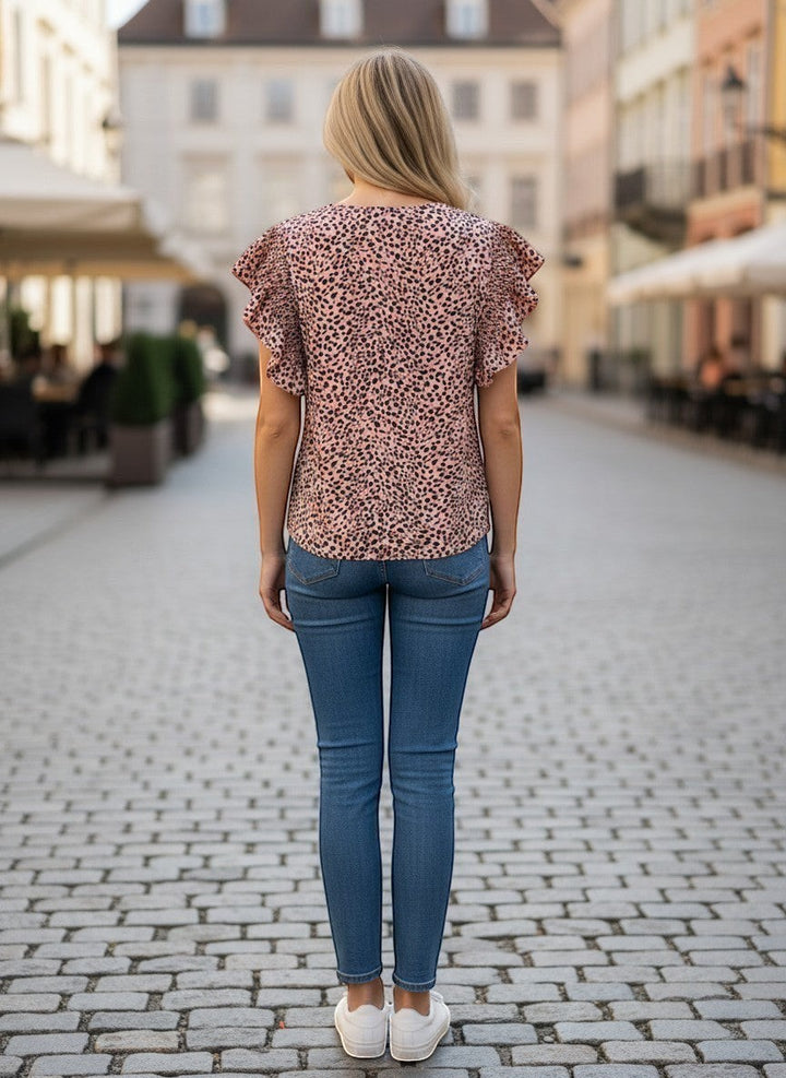 Chic Collective mauve and black leopard print top with ruffle sleeves, paired with blue denim jeans.