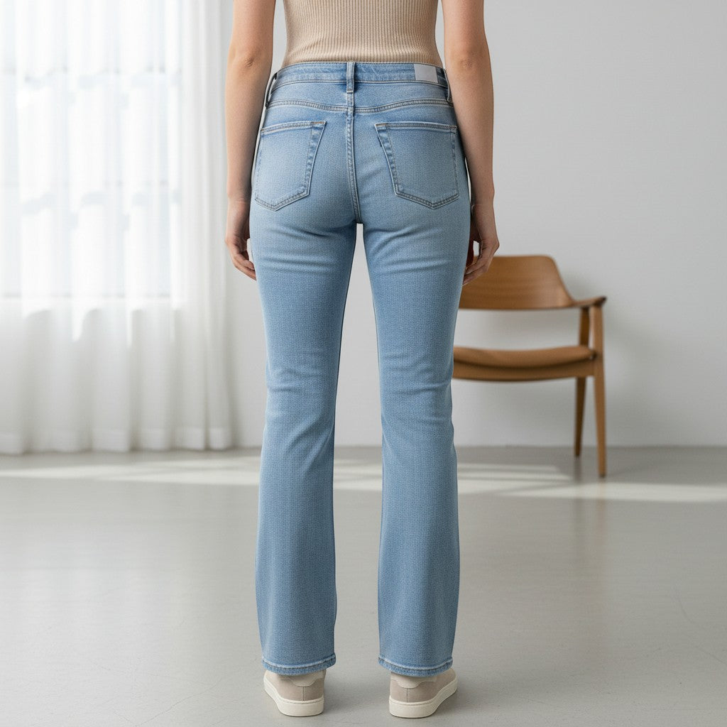 Chic Collective Risen Mid Rise Frayed jeans in light blue denim with a subtle flare and frayed hem.