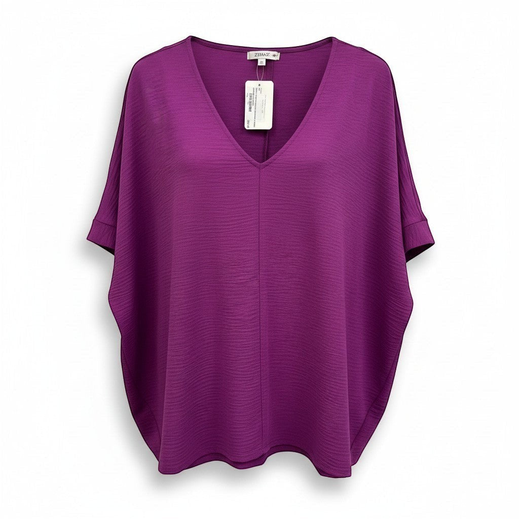 Chic Collective light plum woven dolman top with V-neck and textured fabric. Short dolman sleeves with cuffed hems.