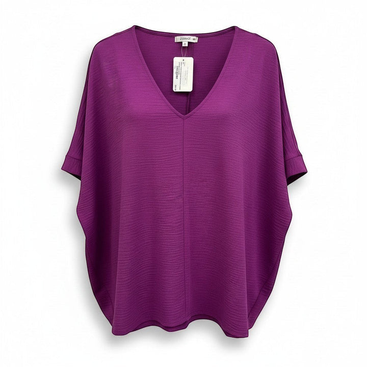 Chic Collective light plum woven dolman top with V-neck and textured fabric. Short dolman sleeves with cuffed hems.