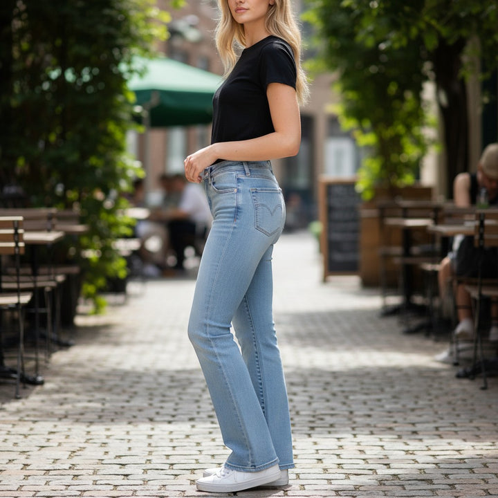 Chic Collective Risen Mid Rise Frayed light wash denim jeans with a straight leg fit. Model is wearing size 13.