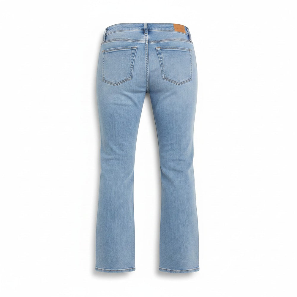 Chic Collective Risen Mid Rise Frayed light wash denim jeans with a slight flare and raw hem, size 5.