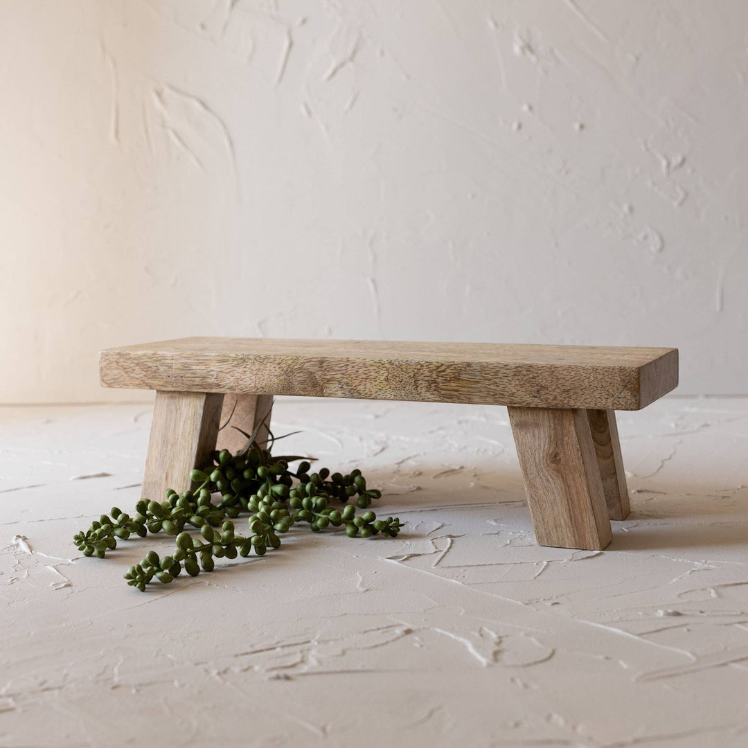 Chic Collective Hazel footed stool riser made of natural mango wood with a rustic farmhouse style.
