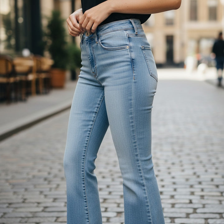 Chic Collective Risen Mid Rise Frayed light wash denim jeans with a slight flare and frayed hem.