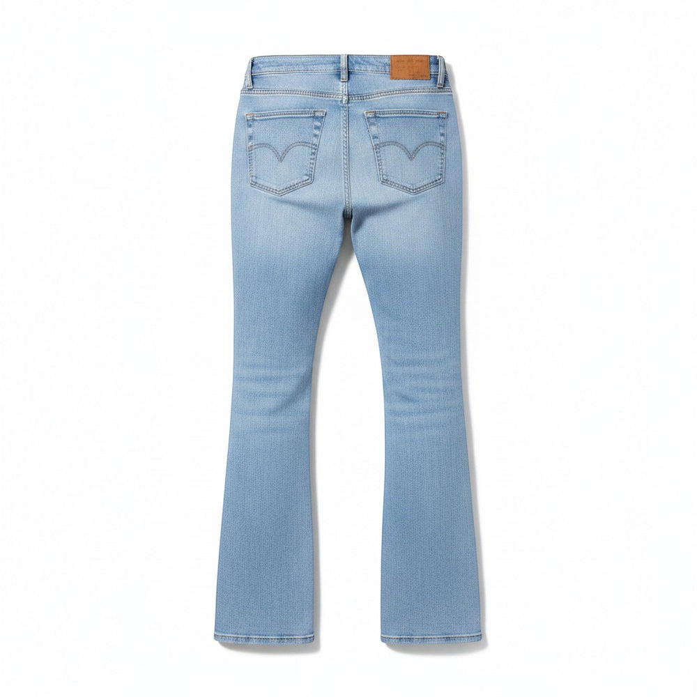 Chic Collective Risen Mid Rise Frayed jeans in light blue denim with a flared leg and signature back pocket stitching.