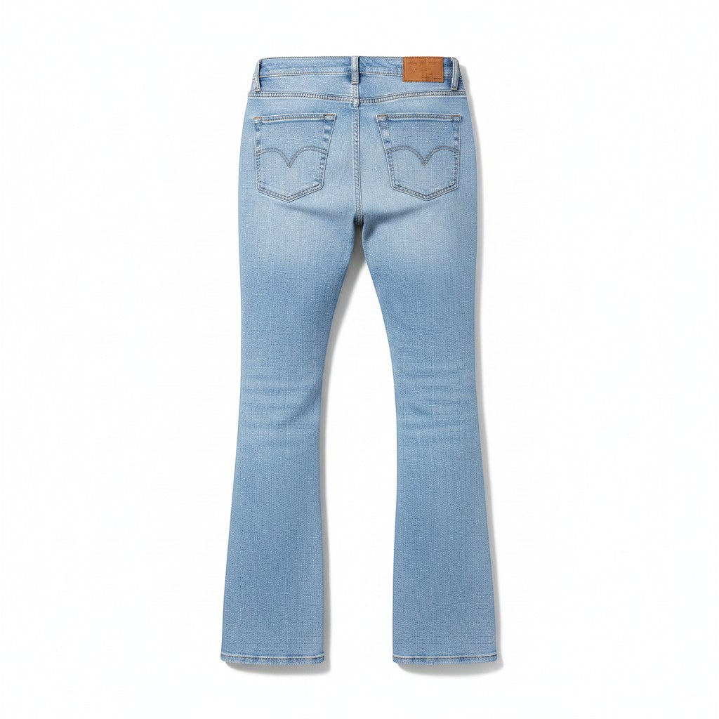 Chic Collective Risen Mid Rise Frayed jeans in light blue denim with a flared leg and signature back pocket stitching.